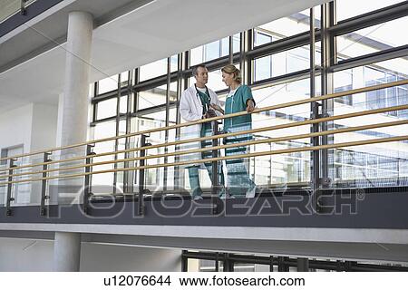 Picture - Physicians talking on Balcony. Fotosearch
