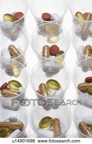 Pills and tablets in plastic cups View Large Photo Image Stock Photo - Pills and tablets in plastic cups. Fotosearch