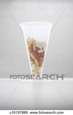 Stock Photo - Pills in funnel. Fotosearch