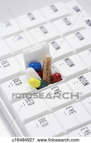 Stock Photo - Pills in open container. Fotosearch