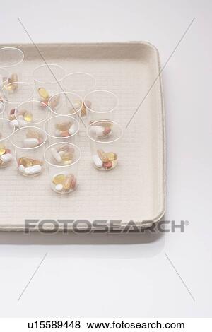 Pills in plastic cups on tray View Large Photo Image Stock Photo - Pills in plastic cups on tray. Fotosearch