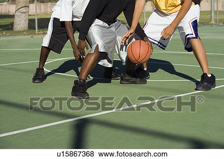 Player being tackled in basketball low section View Large Photo Image Stock Photo - Player being tackled in basketball low section. Fotosearch
