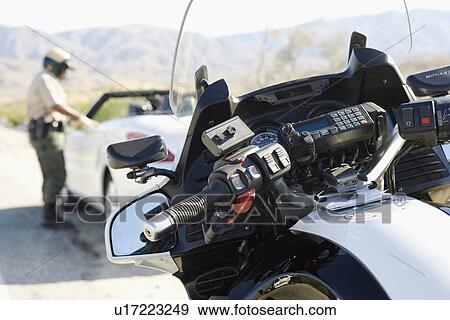 Police officer talking to driver of stopped car on desert highway View Large Photo Image Stock Photo - Police officer talking to driver of stopped car on desert highway. Fotosearch