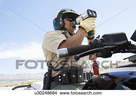 Police officer using radar gun View Large Photo Image Picture - Police officer using radar gun. Fotosearch