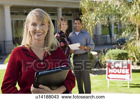 Portrait of smiling estate agent with house and home buyers in background View Large Photo Image Stock Image - Portrait of smiling estate agent with house and home buyers in background. Fotosearch