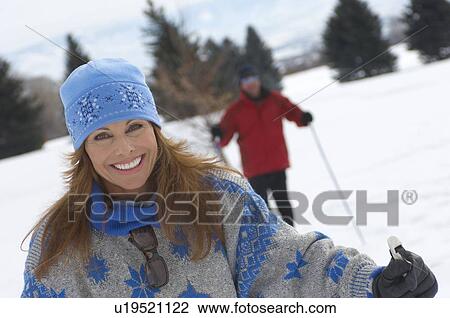 Portrait of smiling mature woman cross country skiing View Large Photo Image Stock Image - Portrait of smiling mature woman cross country skiing. Fotosearch