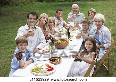 Portrait of three generation family dining in garden View Large Photo Image Stock Photo - Portrait of three generation family dining in garden. Fotosearch
