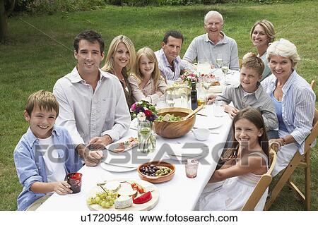 Portrait of three generation family dining in garden View Large Photo Image Stock Photograph - Portrait of three generation family dining in garden. Fotosearch