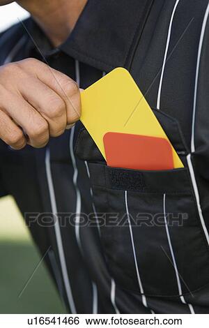 Stock Photograph - Referee taking card from pocket mid section. Fotosearch
