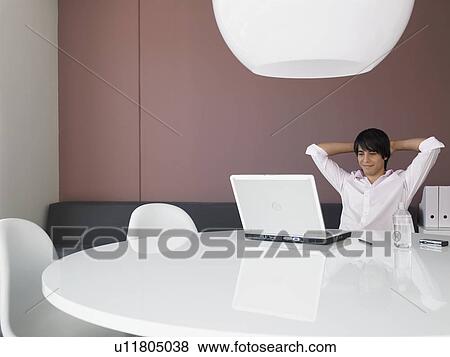 Relaxed Businessman Using Laptop in Modern Office View Large Photo Image Stock Photo - Relaxed Businessman Using Laptop in Modern Office. Fotosearch