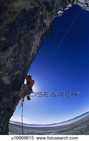 Rock climber on cliff face View Large Photo Image Stock Image - Rock climber on cliff face. Fotosearch
