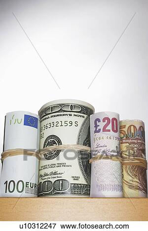 Stock Photo - Rolls of currency on shelf. Fotosearch