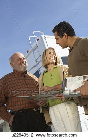 RV salesperson talking to customers low angle view View Large Photo Image Stock Image - RV salesperson talking to customers low angle view. Fotosearch