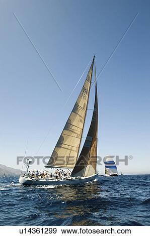 Stock Photo - Sailboat in Race on ocean back view. Fotosearch