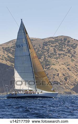 Stock Photo - Sailboat near coast on ocean. Fotosearch
