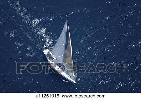 Stock Photography - Sailboat on Ocean elevated view. Fotosearch