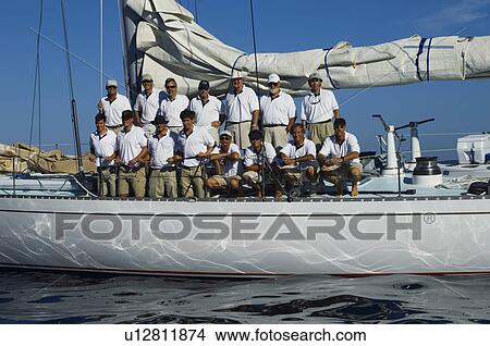 Picture - Sailing crew posing for a group portrait on board yacht. Fotosearch