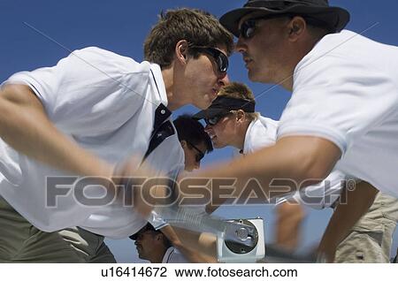 Sailors operating windlass on yacht side view View Large Photo Image Stock Image - Sailors operating windlass on yacht side view. Fotosearch
