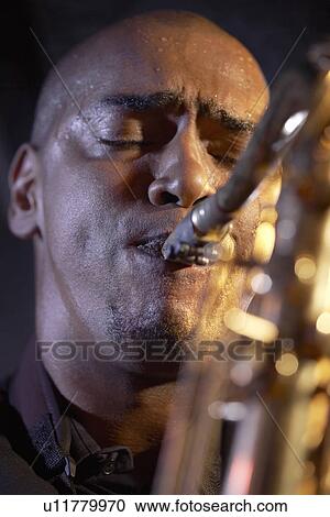 Saxophone player on stage portrait close-up View Large Photo Image Stock Image - Saxophone player on stage portrait close-up. Fotosearch