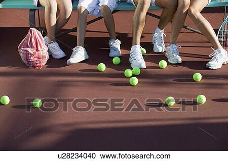 Scattered tennis balls on tennis court by feet of family low section View Large Photo Image Stock Image - Scattered tennis balls on tennis court by feet of family low section. Fotosearch