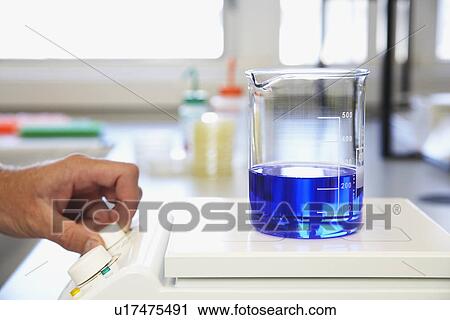 Scientific glass container with blue liquid on apparatus being analysed View Large Photo Image Stock Image - Scientific glass container with blue liquid on apparatus being analysed. Fotosearch