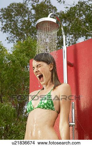 Screaming young woman using outdoor shower low angle view View Large Photo Image Picture - Screaming young woman using outdoor shower low angle view. Fotosearch
