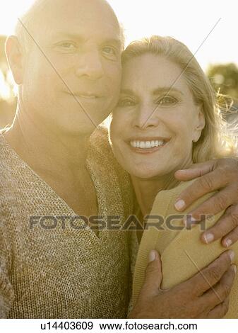 Senior couple embracing at sunset close up View Large Photo Image Stock Photo - Senior couple embracing at sunset close up. Fotosearch