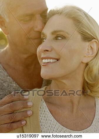 Senior couple embracing at sunset close up View Large Photo Image Stock Photo - Senior couple embracing at sunset close up. Fotosearch