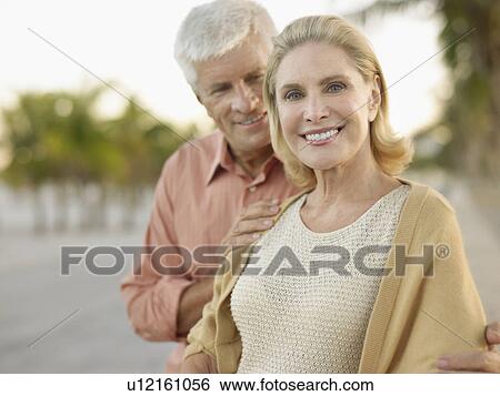 Senior couple palm trees in background View Large Photo Image Stock Photograph - Senior couple palm trees in background. Fotosearch