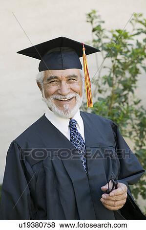 Senior graduate smiling outside portrait View Large Photo Image Stock Photo - Senior graduate smiling outside portrait. Fotosearch