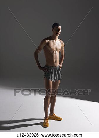 Stock Photograph - Shirtless athlete standing. Fotosearch