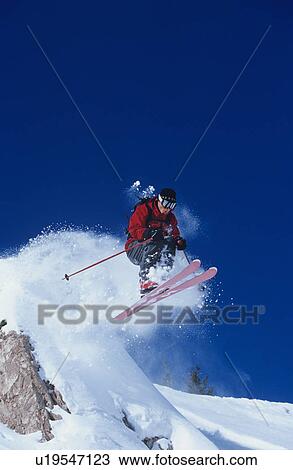 Skier jumping from mountain ledge View Large Photo Image Stock Image - Skier jumping from mountain ledge. Fotosearch