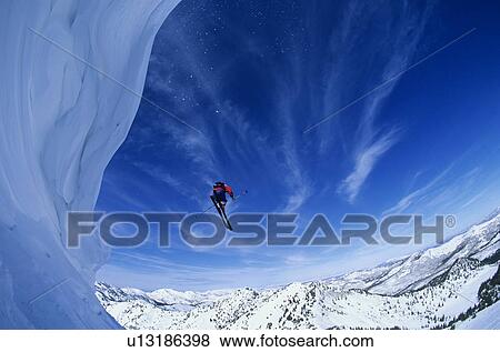 Skier jumping from mountain ledge View Large Photo Image Stock Photo - Skier jumping from mountain ledge. Fotosearch