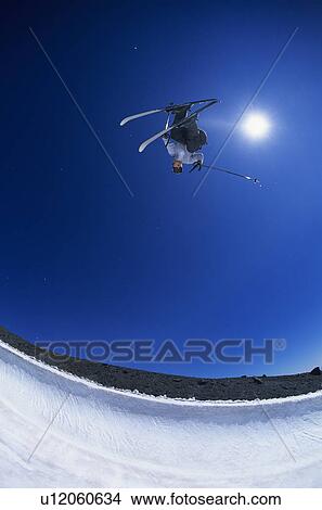 Picture - Skier performing flip on mountain. Fotosearch