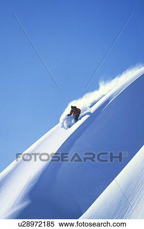 Skier racing down mountain slope View Large Photo Image Stock Photography - Skier racing down mountain slope. Fotosearch