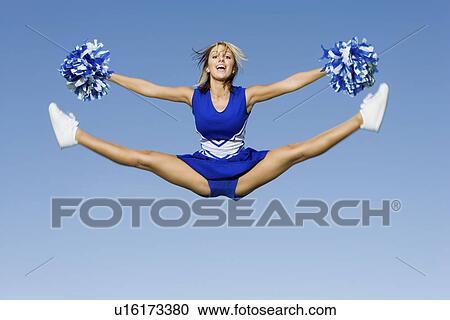 Smiling Cheerleader jumping in mid-air (portrait) View Large Photo Image Stock Image - Smiling Cheerleader jumping in mid-air (portrait). Fotosearch
