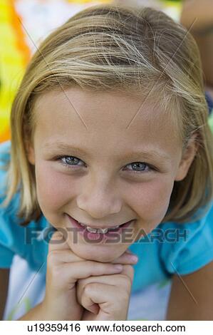 Stock Photograph - Smiling girl (7-9) portrait.. Fotosearch