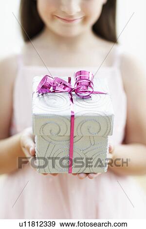 Stock Photo - Smiling Girl with Gift mid section close up. Fotosearch
