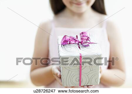 Smiling Girl with Gift mid section close up View Large Photo Image Stock Photo - Smiling Girl with Gift mid section close up. Fotosearch