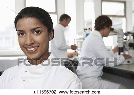 Smiling Lab Worker colleagues behind View Large Photo Image Stock Image - Smiling Lab Worker colleagues behind. Fotosearch