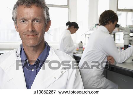 Smiling Lab Worker colleagues behind View Large Photo Image Stock Photo - Smiling Lab Worker colleagues behind. Fotosearch