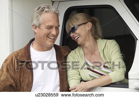Smiling mature couple next to RV View Large Photo Image Stock Photo - Smiling mature couple next to RV. Fotosearch