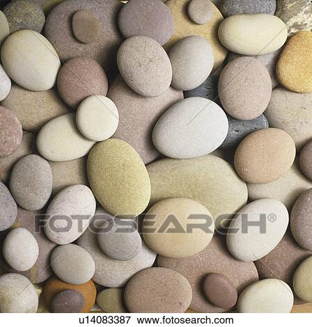 Stock Photo - Smooth pebbles stones (close-up). Fotosearch