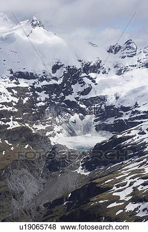 Stock Photo - Snow-covered mountain peaks. Fotosearch