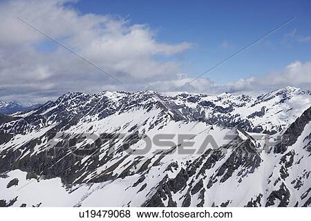 Stock Photo - Snow-covered mountain peaks. Fotosearch