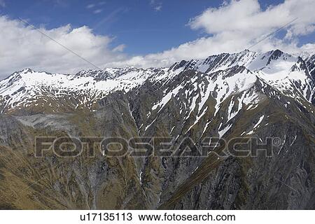Snow-streaked mountain peaks View Large Photo Image Stock Image - Snow-streaked mountain peaks. Fotosearch