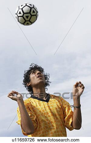 Soccer player heading ball portrait View Large Photo Image Stock Photograph - Soccer player heading ball portrait. Fotosearch