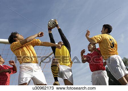 Soccer players jumping for ball View Large Photo Image Stock Image - Soccer players jumping for ball. Fotosearch