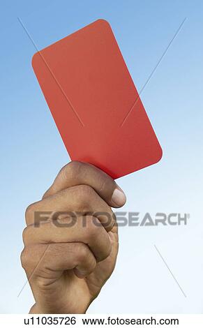 Soccer referee holding up red card close-up on hand View Large Photo Image Stock Photograph - Soccer referee holding up red card close-up on hand. Fotosearch