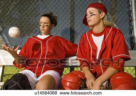 Softball players sitting on bench portrait View Large Photo Image Stock Photo - Softball players sitting on bench portrait. Fotosearch